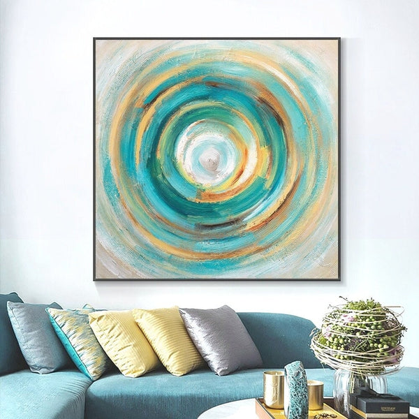 Green and blue circular abstract canvas painting above a sofa — Sona Casa