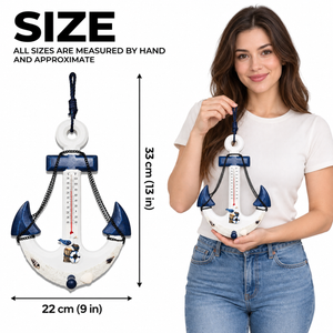 Nautical anchor wall thermometer with size labels and a person holding it for scale